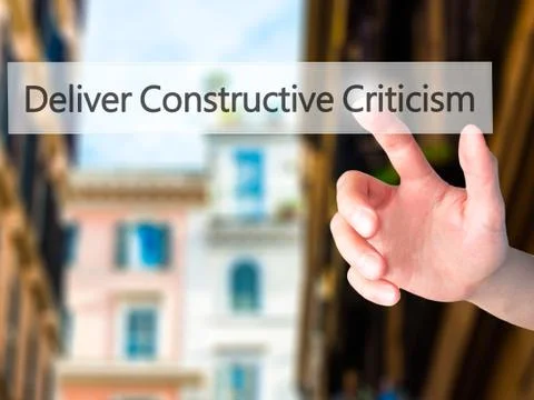 Deliver Constructive Criticism - Hand pressing a button on blurred background Stock Photos
