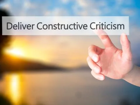 Deliver Constructive Criticism - Hand pressing a button on blurred background Stock Photos