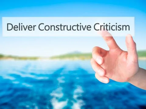 Deliver Constructive Criticism - Hand pressing a button on blurred background Stock Photos