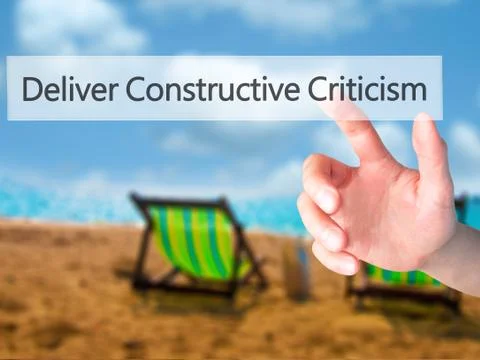 Deliver Constructive Criticism - Hand pressing a button on blurred background Stock Photos