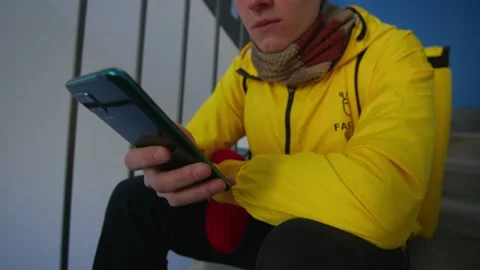 The deliverer interacts with the phone Stock Footage 236898517
