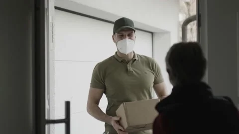 Delivering a package with a mask on Stock Footage 149293846
