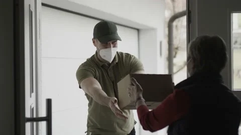 Delivering a package with a mask on Stock Footage 149294068