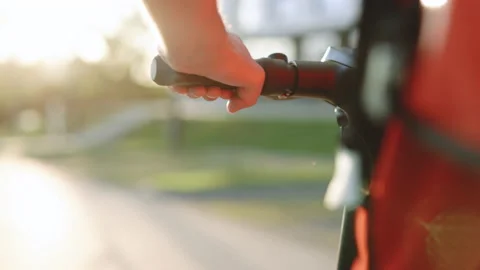 Deliverman courier with isothermal backpack case pizza box rides his electric Stock Footage 194595856