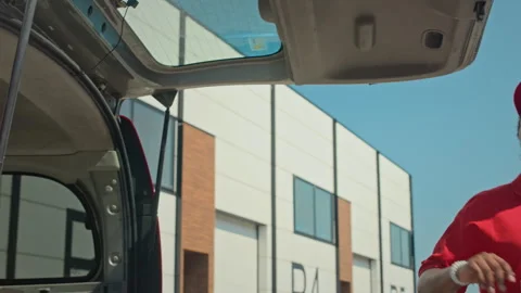 Delivery Agent Taking Package out of van Trunk Stock Footage 280374343