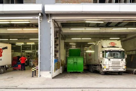 Delivery area with opened rolling gates behind a supermarket. Stock Photos