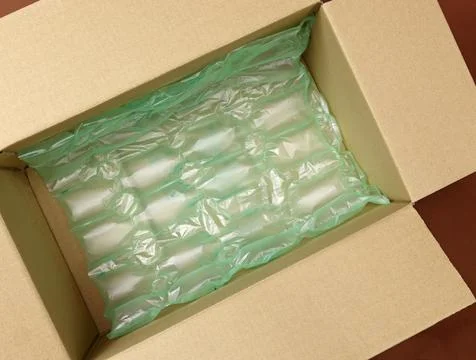 Delivery box filled with plastic bubble wrap. Stock Photos