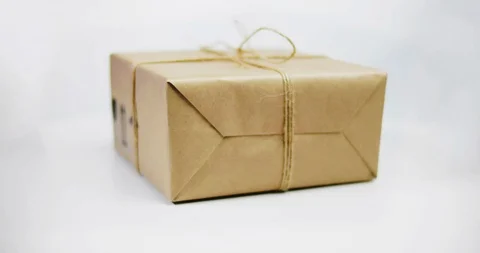 Delivery box wrapped with kraft paper with rope bow Stock Footage 98765713