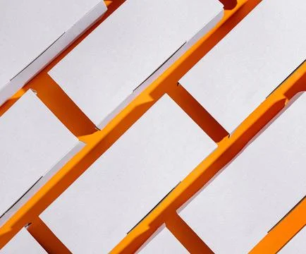 Delivery boxes arranged in a dynamic pattern on an orange background Stock Photos