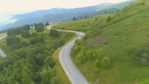 Delivery bus driving down the mountain road Stock Footage 135670169