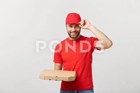 Delivery Concept: Young haapy caucasian Handsome Pizza delivery man holding Stock Photos