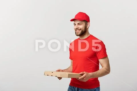 Delivery Concept: Young haapy caucasian Handsome Pizza delivery man holding Stock Photos