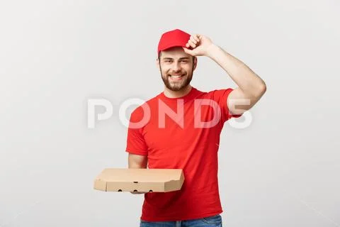 Delivery Concept: Young haapy caucasian Handsome Pizza delivery man holding Stock Photos