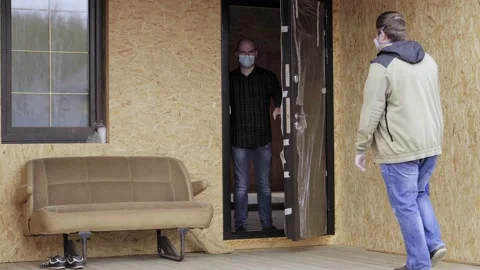 Delivery courier package isolation coronavirus covid house man door general plan Stock Footage 130205024