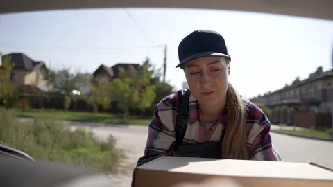 Delivery courier unloading boxes from car trunk Video stock 194787848