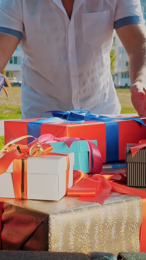 Delivery. donation, charity. gift boxes in car. close-up. man and woman unload Stock Footage 318146249