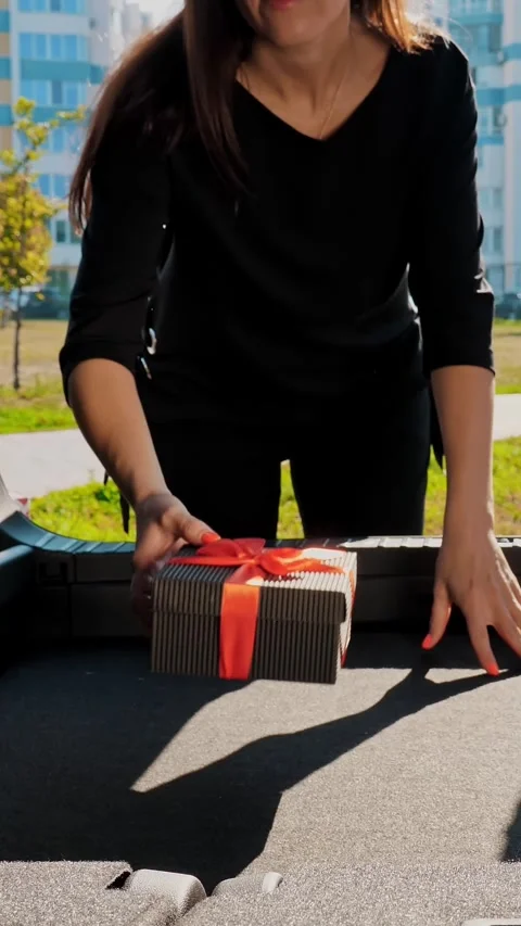 Delivery. donation, charity. gift boxes in car. close-up. man and woman load Stock Footage 318146495