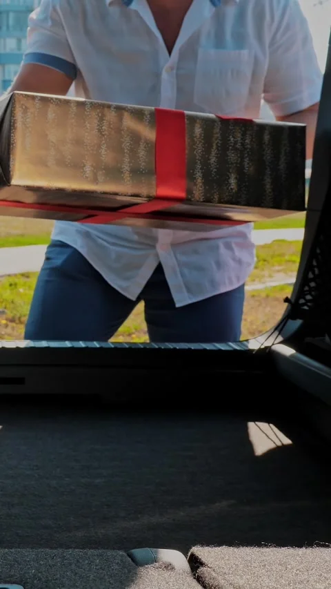 Delivery. donation, charity. gift boxes in car. close-up. man and woman load Stock Footage 318246960