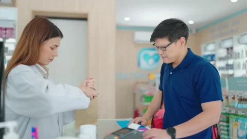 Delivery driver consult headache and buy medicine with pharmacist at pharmacy Stock Footage 218229228
