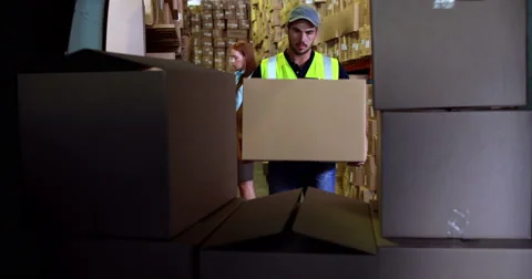 Delivery driver loading his van with boxes Stock Footage
