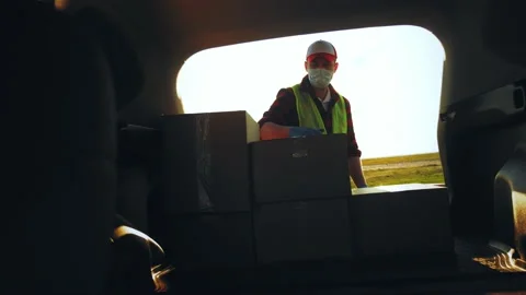 Delivery driver loading his van with box... | Stock Video | Pond5