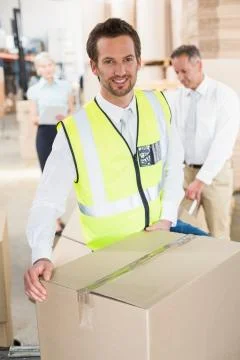 Delivery driver loading his van with boxes Stock Photos