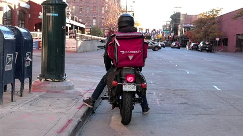 Delivery driver on a motorcycle Stock Footage 219889299