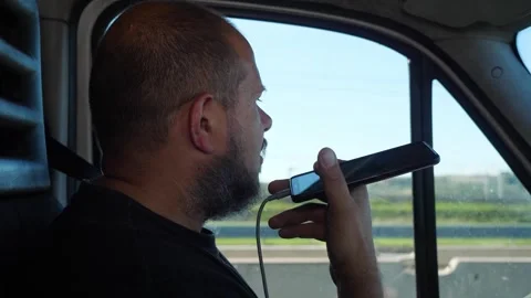 Delivery driver recording voice message while driving dangerously Video stock 332422911