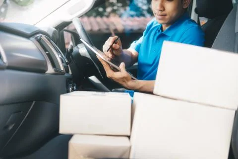 Delivery driver using digital tablet. Stock Photos
