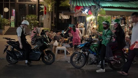 Delivery Drivers Checking Phones on Motorbikes in Saigon Stockbeeldmateriaal 331786728