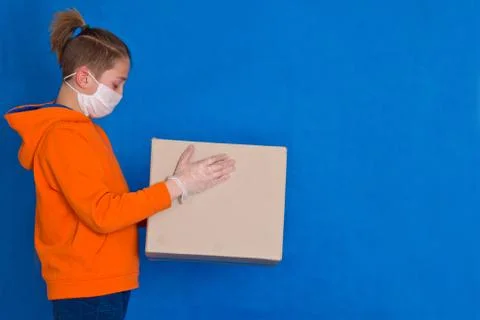 Delivery gloves mask face solves only cardboard box on strong studio work Qua Stock Photos
