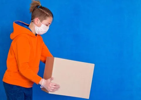 Delivery gloves mask face solves only cardboard box on strong studio work Qua Stock Photos