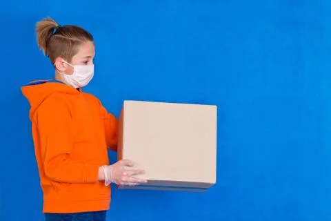 Delivery gloves mask face solves only cardboard box on strong studio work Qua Stock Photos