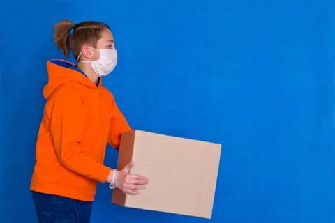 Delivery gloves mask face solves only cardboard box on strong studio work Qua Stock Photos