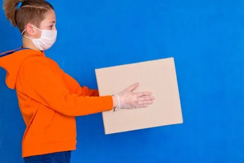 Delivery gloves mask face solves only cardboard box on strong studio work Qua Stock Photos