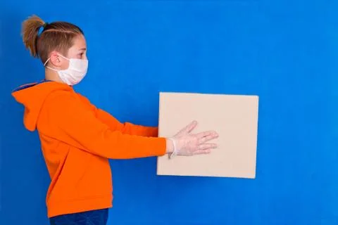 Delivery gloves mask face solves only cardboard box on strong studio work Qua Stock Photos