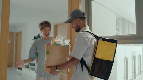 Delivery Guy Bringing Groceries to Young Woman at Home Stock Footage 238779305