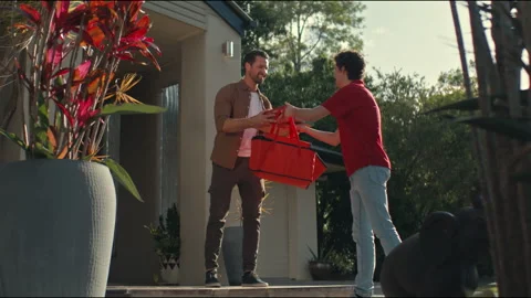 Delivery guy handing over the order to the customer Stock Footage 263908798