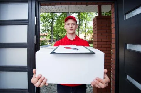 Delivery guy handing in parcel Stock Photos