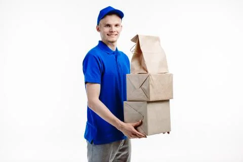 Delivery guy has a stack of boxes in hands. Stock Photos