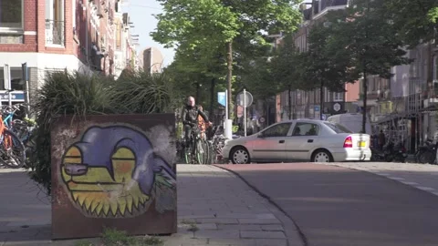 Delivery Guy Thuisbezorgd biking through Amsterdam Stock Footage 130209466