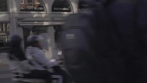 Delivery Guy Thuisbezorgd biking through Amsterdam Stock Footage 130209489