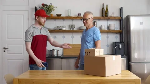 Delivery guy use cellphone for scanning qr-code on retired client wrist to pay Stock Footage 133912001