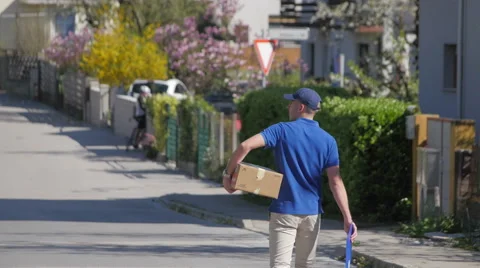 Delivery guy walking down the street Stock Footage 49789736