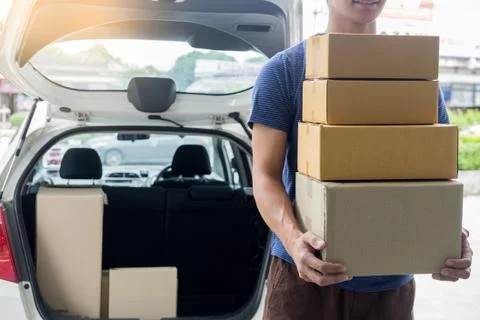 Delivery Loader Postman in blue uniform holding pile of cardboard box or carr Foto stock