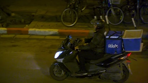 Delivery man with blue delivery box, rides a motorbike Video stock 128209253