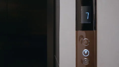 Delivery man calling elevator in modern building Video stock 322512462