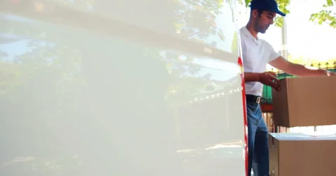 Delivery man carrying parcels Stock-Footage 62394565