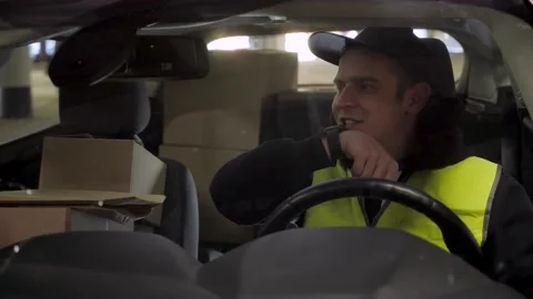 Delivery man checking smartwatch and sending voice message, ready for work Stock Footage 145796787