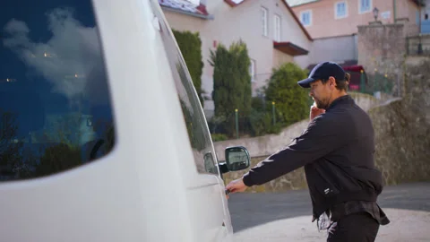 Delivery man courier delivering parcel box in town using smartphone. Stock Footage 131048201